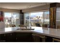 Open kitchen featuring counter seating and a large window with city views at 3111 Bel Air Dr # 15G, Las Vegas, NV 89109
