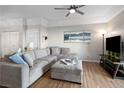 Comfortable living room with a large gray sectional, wood floors, and a modern TV setup for relaxed living at 3550 Bay Sands Dr # 2101, Laughlin, NV 89029
