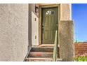 Close-up of the home's inviting front door with stairs and a stylish exterior light fixture at 3592 Gloucester Gate St, Las Vegas, NV 89122
