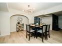 Inviting dining room with a modern table set for eight, elegant lighting, and stylish decor at 3789 Heritage Ave, Las Vegas, NV 89121
