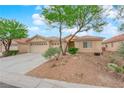 Charming single-story home featuring a three-car garage and desert landscaping at 4029 Ricebird Way, North Las Vegas, NV 89084