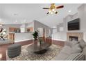 Bright living room with modern furnishings, fireplace, and seamless flow into the kitchen area, perfect for entertaining at 4029 Ricebird Way, North Las Vegas, NV 89084