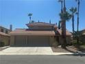 Two-story home with a terracotta roof, desert landscaping, and a two-car garage at 4732 Illustrious St, Las Vegas, NV 89147