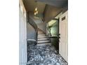 Elegant foyer showcases a staircase with iron railing and distinctive marble flooring, welcoming guests into the home at 4732 Illustrious St, Las Vegas, NV 89147