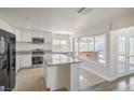 Bright kitchen with granite countertops, an island, stainless steel appliances, and backyard access at 4889 W Montara Cir, Las Vegas, NV 89121