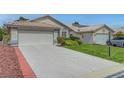 Lovely single-story home with a spacious driveway and verdant landscaping at 4924 Cedar Lawn Way, Las Vegas, NV 89130