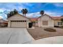 Charming single-story home featuring a two-car garage, desert landscaping, and a classic red tile roof at 5124 Appealing Ct, Las Vegas, NV 89130