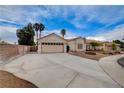 A well-manicured front yard shows a charming single-story home with desert landscaping, and a two-car garage at 5124 Appealing Ct, Las Vegas, NV 89130