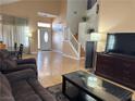 The bright living room features high ceilings, and wood laminate flooring at 5255 Autumn Sky Rd, Las Vegas, NV 89118