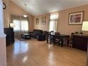 This cozy living room has soaring vaulted ceilings, wood laminate flooring, and lots of natural light at 5255 Autumn Sky Rd, Las Vegas, NV 89118