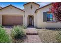 Inviting entrance featuring a beautiful front door, desert landscaping, and a brick walkway at 5713 Silver Cascade Ave, Las Vegas, NV 89131