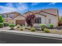 Attractive home with desert landscaping, a tile roof, and a two-car garage at 5713 Silver Cascade Ave, Las Vegas, NV 89131