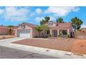Charming single-story home with a two-car garage and desert landscaping at 5900 Red Umber Ave, Las Vegas, NV 89130