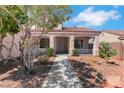 Inviting covered front porch with desert landscaping and a charming entryway at 5900 Red Umber Ave, Las Vegas, NV 89130