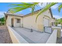 Side view of a well-maintained single-story home with a concrete yard and a two-car garage at 6001 Falconer Ave, Las Vegas, NV 89122