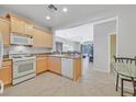 Bright kitchen featuring light wood cabinets and modern appliances at 6001 Falconer Ave, Las Vegas, NV 89122