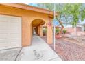 Covered front porch and walkway leading to the front door and attached garage at 632 Arrayo Way, Boulder City, NV 89005
