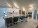 Spacious kitchen features a large island, stainless steel appliances, and sleek white cabinetry at 7527 Ardenno St, North Las Vegas, NV 89084