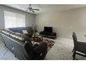 Comfortable living room with marble floors and large windows at 7527 Ardenno St, North Las Vegas, NV 89084