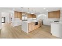Bright kitchen with island featuring a microwave and beautiful wood accents at 7616 Gossamer Wind St, Las Vegas, NV 89139