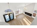 Bright open living space featuring high ceilings, modern fireplace and black framed doorway at 7616 Gossamer Wind St, Las Vegas, NV 89139