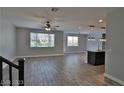 Open living room featuring wood-look tile flooring and lots of natural light at 7733 Donner Peak St, Las Vegas, NV 89166