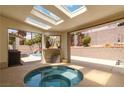 Enclosed patio with a relaxing hot tub and scenic backyard views, perfect for entertaining at 8326 Mount Nido Dr, Las Vegas, NV 89147