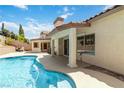 Relax by the inviting pool and covered patio in this well-maintained backyard at 8326 Mount Nido Dr, Las Vegas, NV 89147