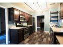 Well-lit kitchen with wooden cabinets, stainless steel appliances, and hardwood flooring at 9000 Litchfield Ave, Las Vegas, NV 89134