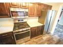 Kitchen showcasing stainless steel appliances and dark cabinetry offering a stylish aesthetic at 9000 Litchfield Ave, Las Vegas, NV 89134