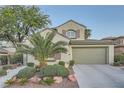 Charming two-story home featuring a well-manicured front yard with lush greenery and a spacious two-car garage at 11345 Espadrille Ct, Las Vegas, NV 89138