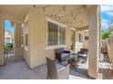Relaxing covered patio with stylish furniture and string lights at 1525 Spiced Wine Ave # 14105, Henderson, NV 89074