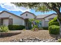 Inviting single-story home with desert landscaping, rocks, and bushes at 1613 Williamsport St, Henderson, NV 89052