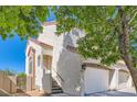 Corner view of two-story home, with desert landscaping, stucco walls, tile roof, and a two-car garage at 1672 Cloister Ave, Henderson, NV 89014