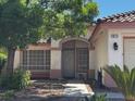 Inviting home with large front window, desert landscaping, a bench, and arched entryway at 1812 Jack Rabbit Way, Las Vegas, NV 89128