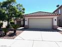 Beautiful home with a tile roof, well-maintained landscaping, and a spacious driveway leading to a two-car garage at 1812 Jack Rabbit Way, Las Vegas, NV 89128