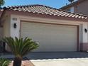 Exterior photo of a home showcasing a two-car garage and desert landscaping at 1812 Jack Rabbit Way, Las Vegas, NV 89128