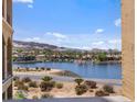 Beautiful lake view showcasing waterfront homes and a mountain backdrop at 20 Via Mantova # 208, Henderson, NV 89011