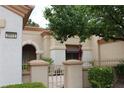Inviting front entrance with gated courtyard and desert landscaping features at 2013 Capestone St, Las Vegas, NV 89134