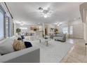 Open-concept living room with view of kitchen and dining area, featuring neutral tones at 2056 Oliver Springs St, Henderson, NV 89052