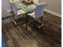 Modern dining area featuring a glass table and stylish chairs set on a wooden floor, perfect for gatherings at 2200 S Fort Apache Rd # 2071, Las Vegas, NV 89117