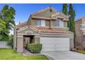 Charming two-story home featuring a terracotta roof, attached two-car garage, and low maintenance landscaping at 2429 Sun Shores Dr, Las Vegas, NV 89128