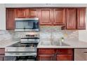 Modern kitchen with stainless steel appliances, a double sink, and ample counter space for food preparation at 2451 N Rainbow Blvd # 2144, Las Vegas, NV 89108