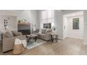 Cozy living room with fireplace, stylish decor, and seamless transition to entry at 2451 Old Forge Ln # 105, Las Vegas, NV 89121