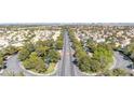 Panoramic aerial view of a lush community with mature trees and a distant city skyline at 2708 Norbeck St, Las Vegas, NV 89117
