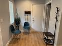 Welcoming foyer with wood-look floors, seating, and modern coat storage at 3400 Denali Preserve St, Las Vegas, NV 89122