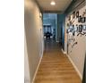 Hallway with wood-look floors and decor leading to dining area at 3400 Denali Preserve St, Las Vegas, NV 89122