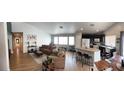 Open-concept living room and kitchen with modern finishes and ample natural light at 3400 Denali Preserve St, Las Vegas, NV 89122