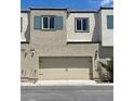 Contemporary townhome with a two-car garage, neutral stucco exterior, and modern architectural details at 3534 Alpheus River Ave, Las Vegas, NV 89106