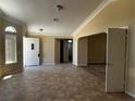 Tiled living room with large windows and neutral colors, offering a bright and welcoming atmosphere at 3750 S Rainbow Ave, Pahrump, NV 89048